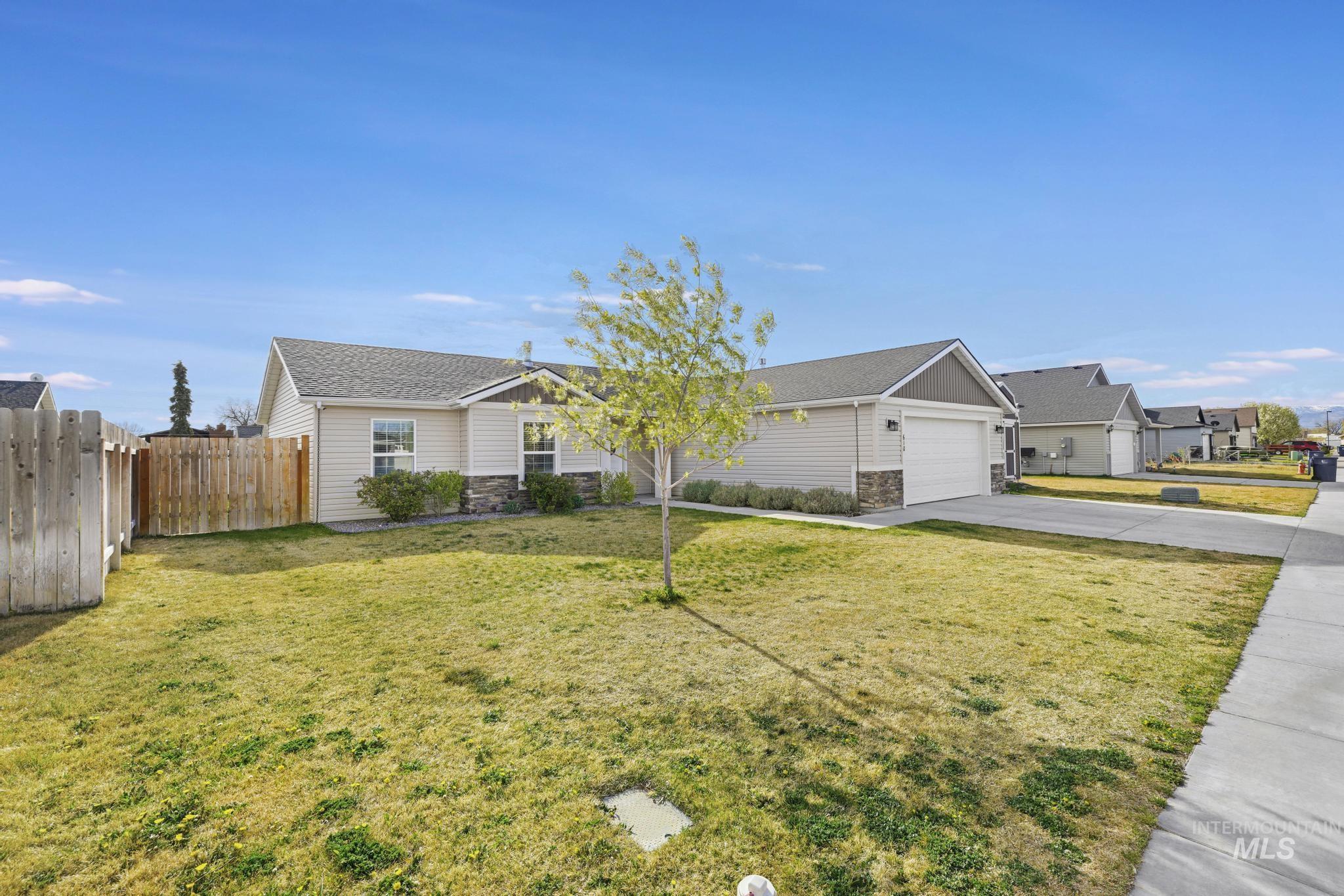 610 South B Street Rupert, ID 83350 - Photo 3 of 26 Single story home featuring stone siding, driveway, a garage, and roof with shingles