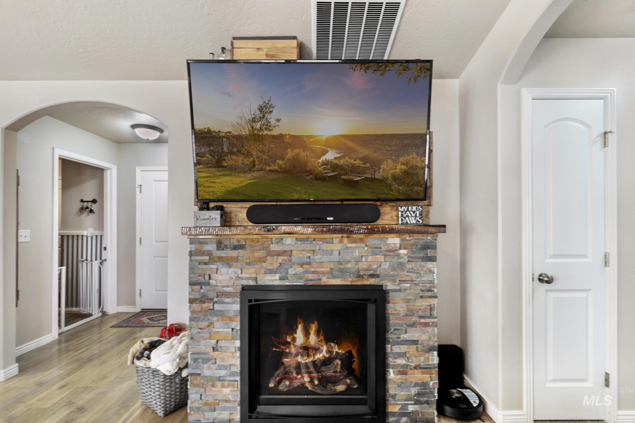 610 South B Street Rupert, ID 83350 - Photo 8 of 26 Detailed view of arched walkways, a fireplace, and wood finished floors
