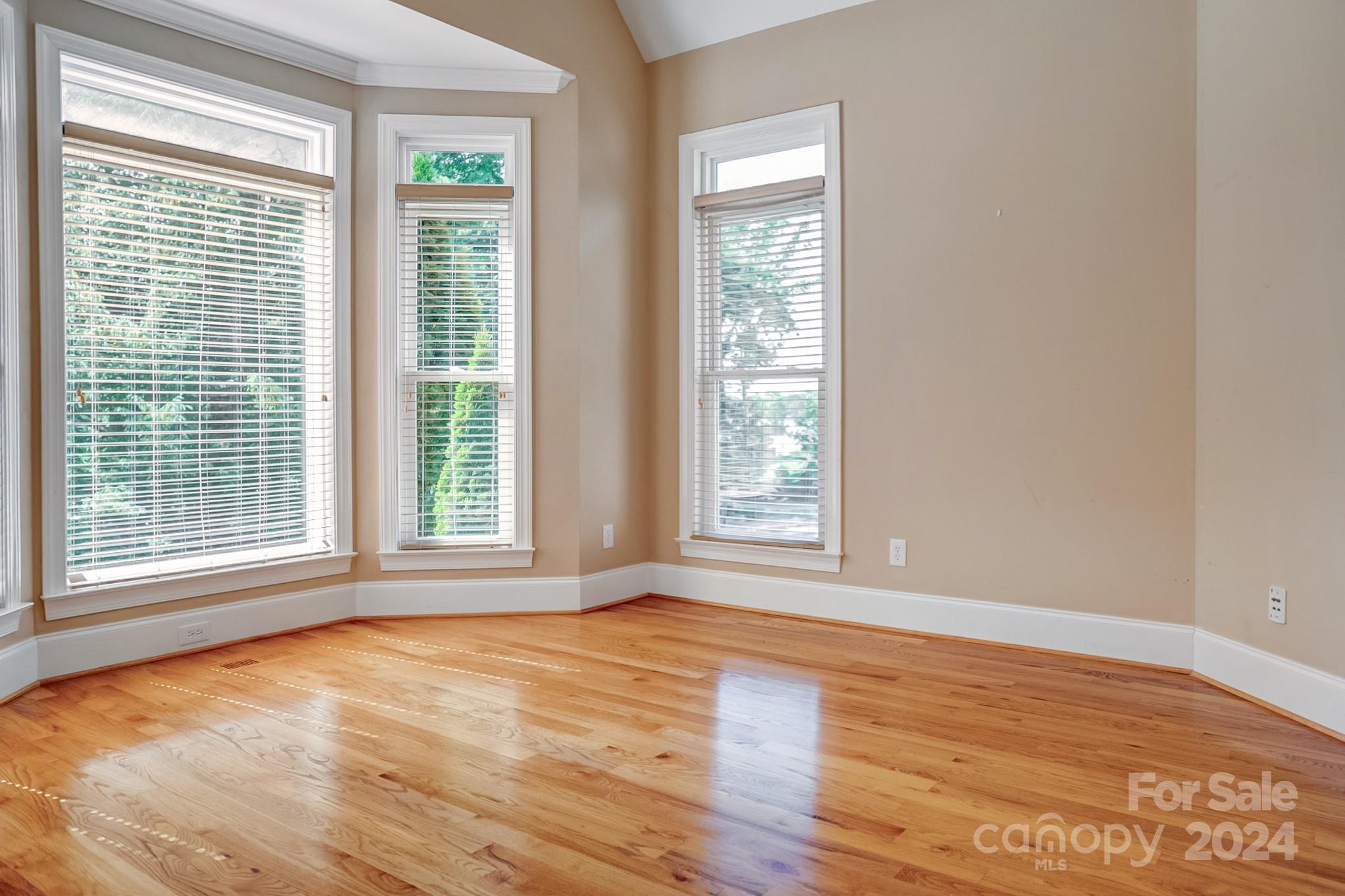 693 Normandy Road Mooresville, NC 28117 - Photo 12 of 48 a view of an empty room with wooden floor and a window