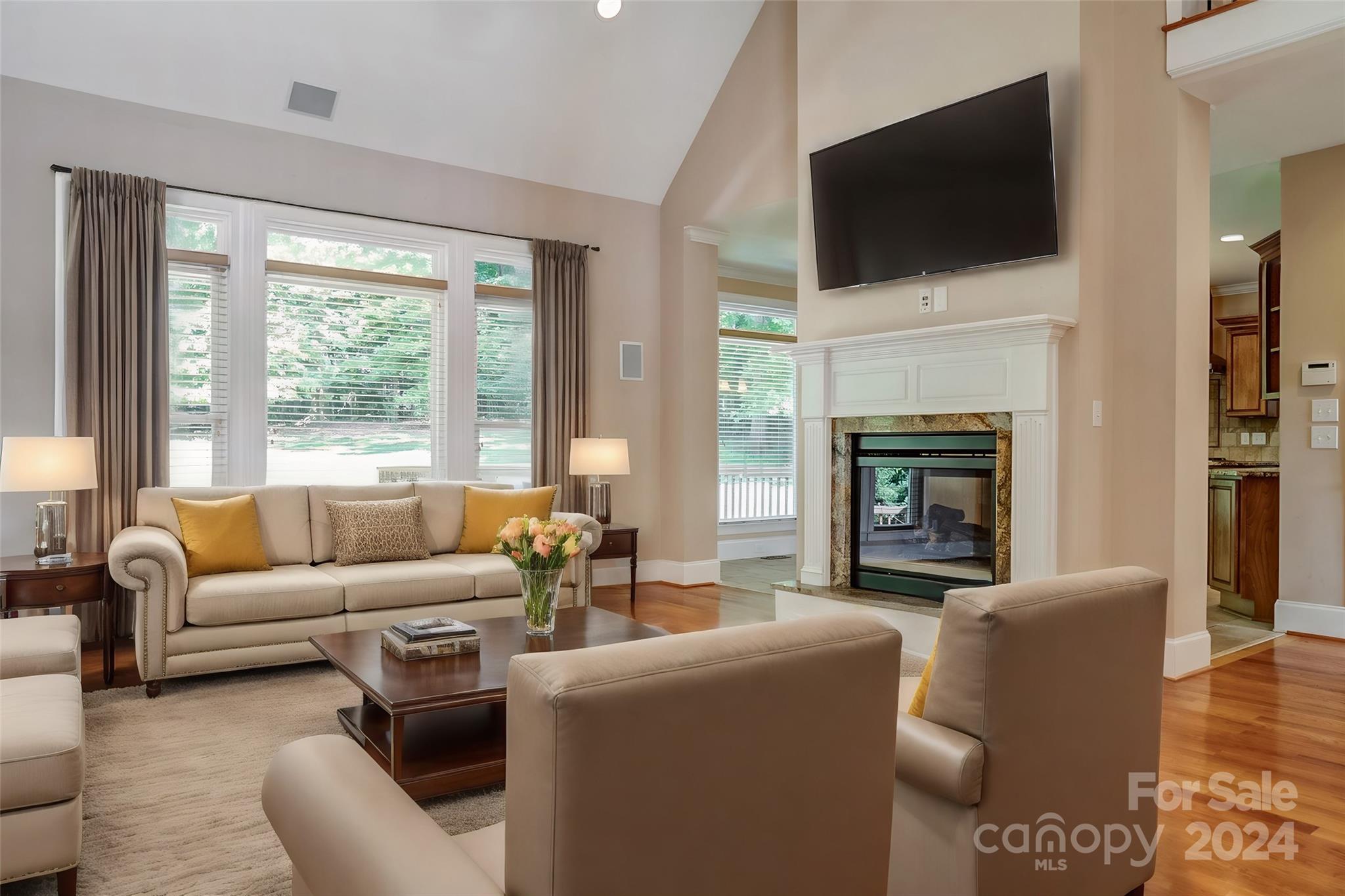 693 Normandy Road Mooresville, NC 28117 - Photo 13 of 48 a living room with furniture a fireplace and a flat screen tv