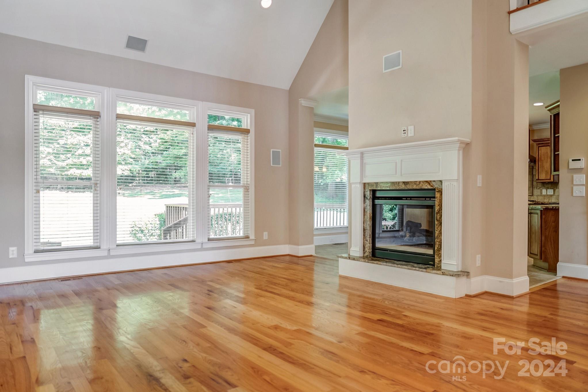 693 Normandy Road Mooresville, NC 28117 - Photo 14 of 48 a view of an empty room with wooden floor and a window