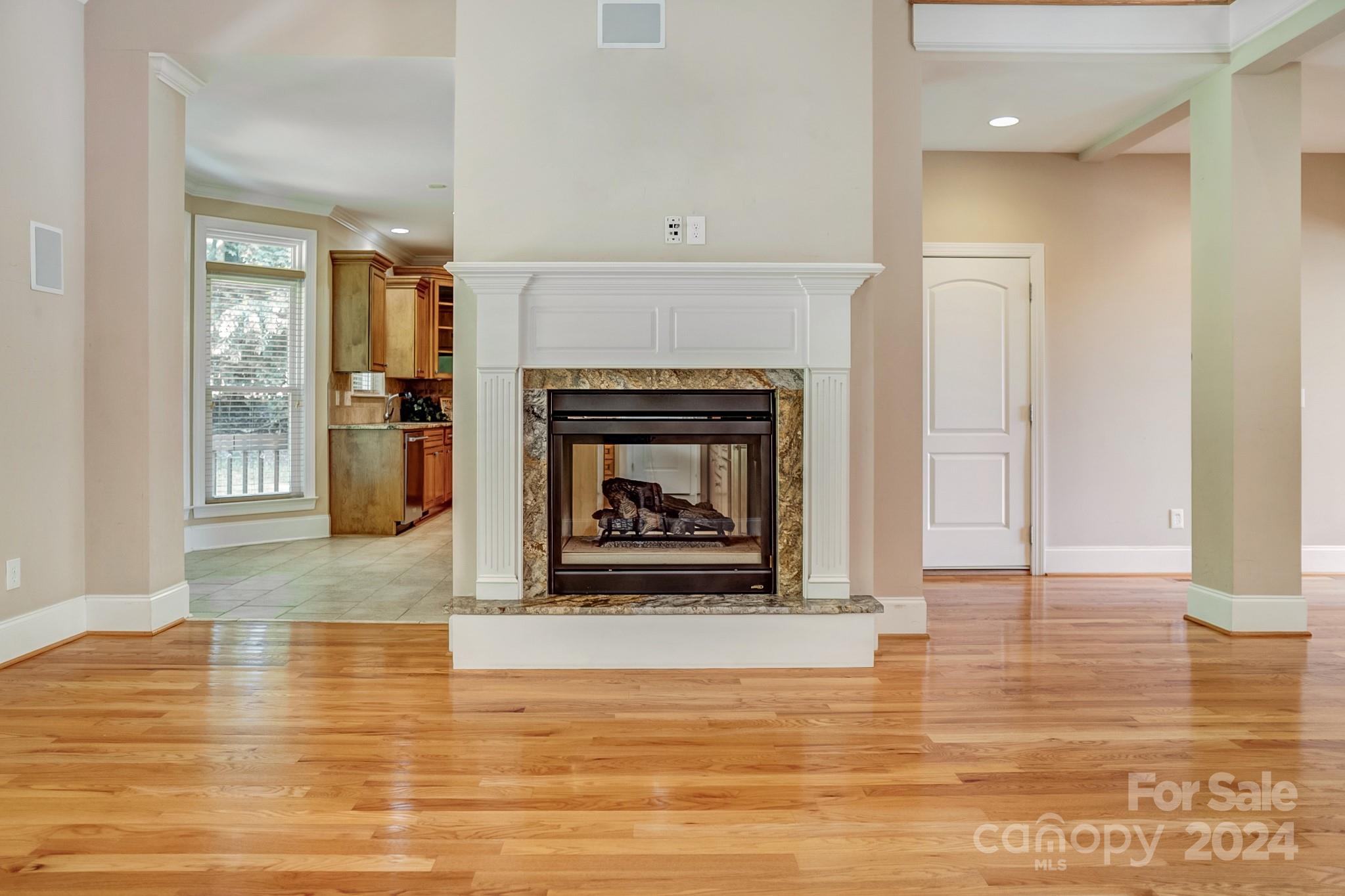 693 Normandy Road Mooresville, NC 28117 - Photo 15 of 48 a view of a livingroom with a fireplace wooden floor and windows