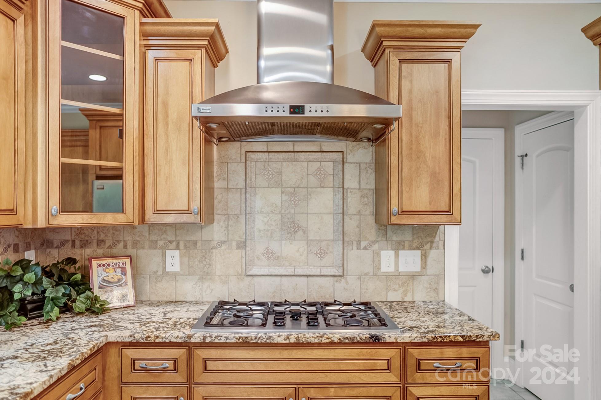 693 Normandy Road Mooresville, NC 28117 - Photo 20 of 48 a kitchen with granite countertop a stove and cabinets