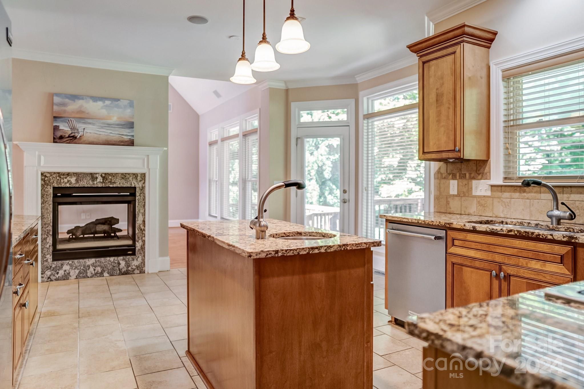693 Normandy Road Mooresville, NC 28117 - Photo 21 of 48 a kitchen with kitchen island granite countertop a stove top oven a sink a dining table and chairs