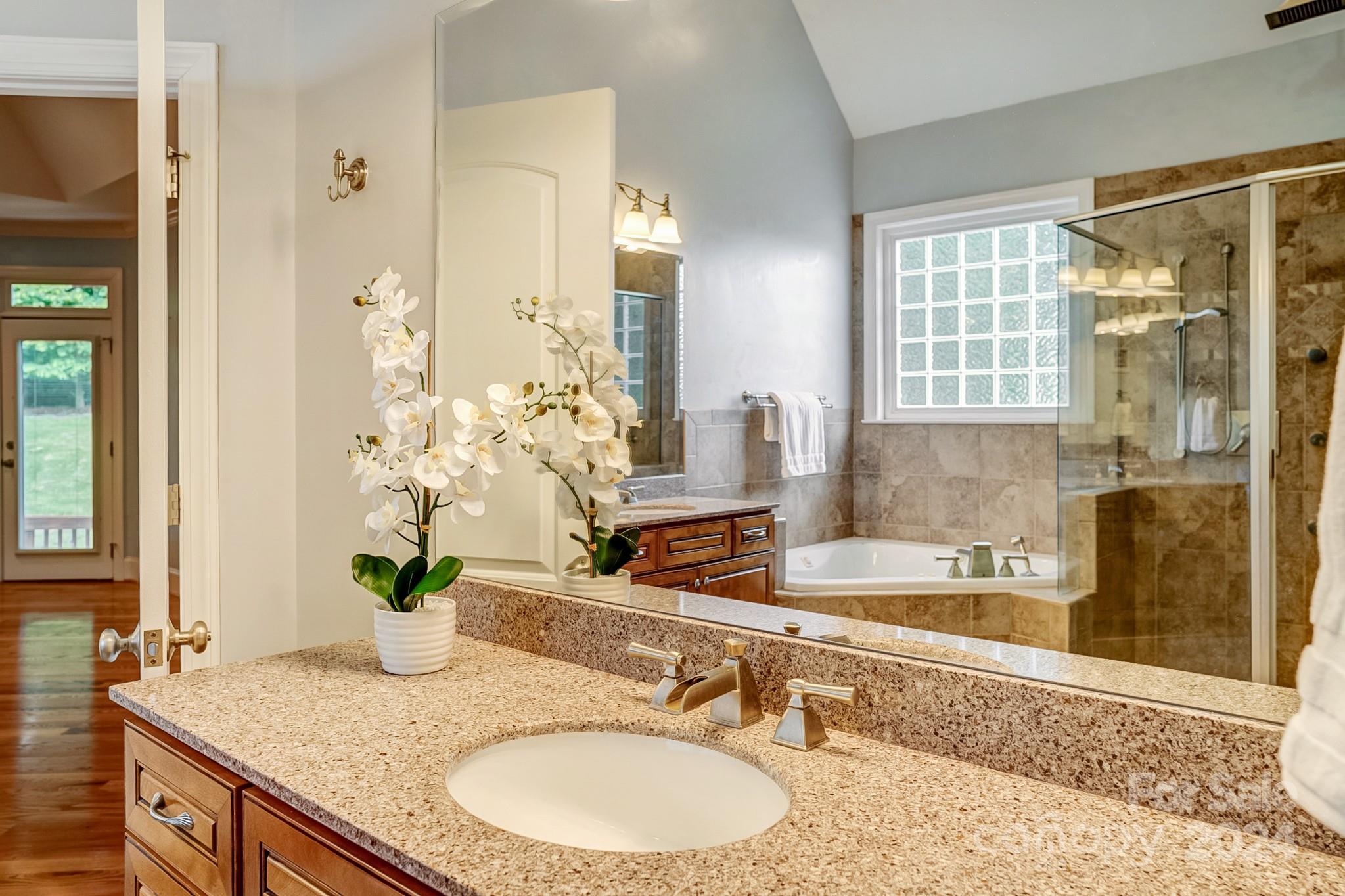 693 Normandy Road Mooresville, NC 28117 - Photo 29 of 48 a bathroom with a granite countertop sink and a mirror
