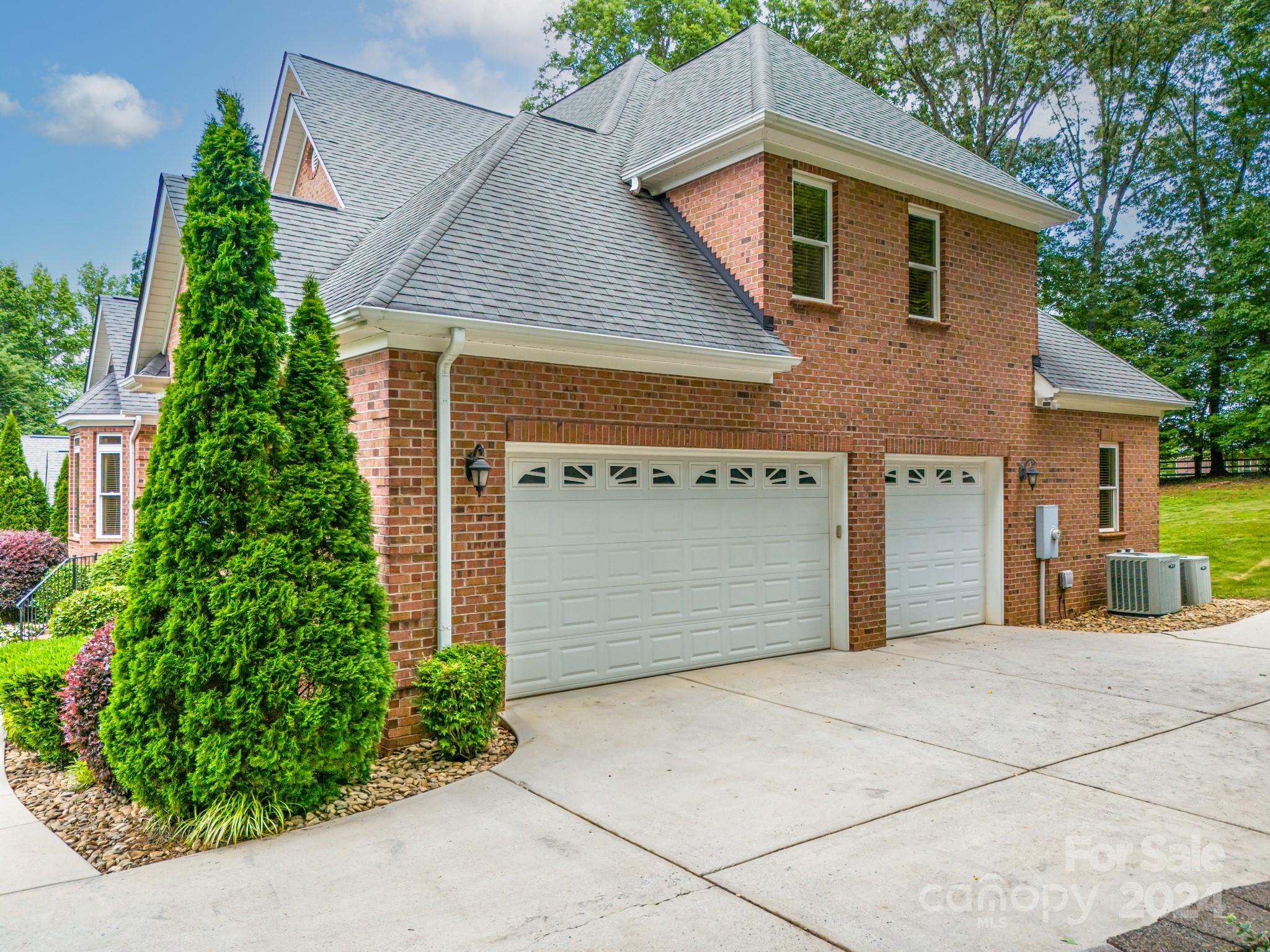693 Normandy Road Mooresville, NC 28117 - Photo 3 of 48 a front view of a house with a garden and garage