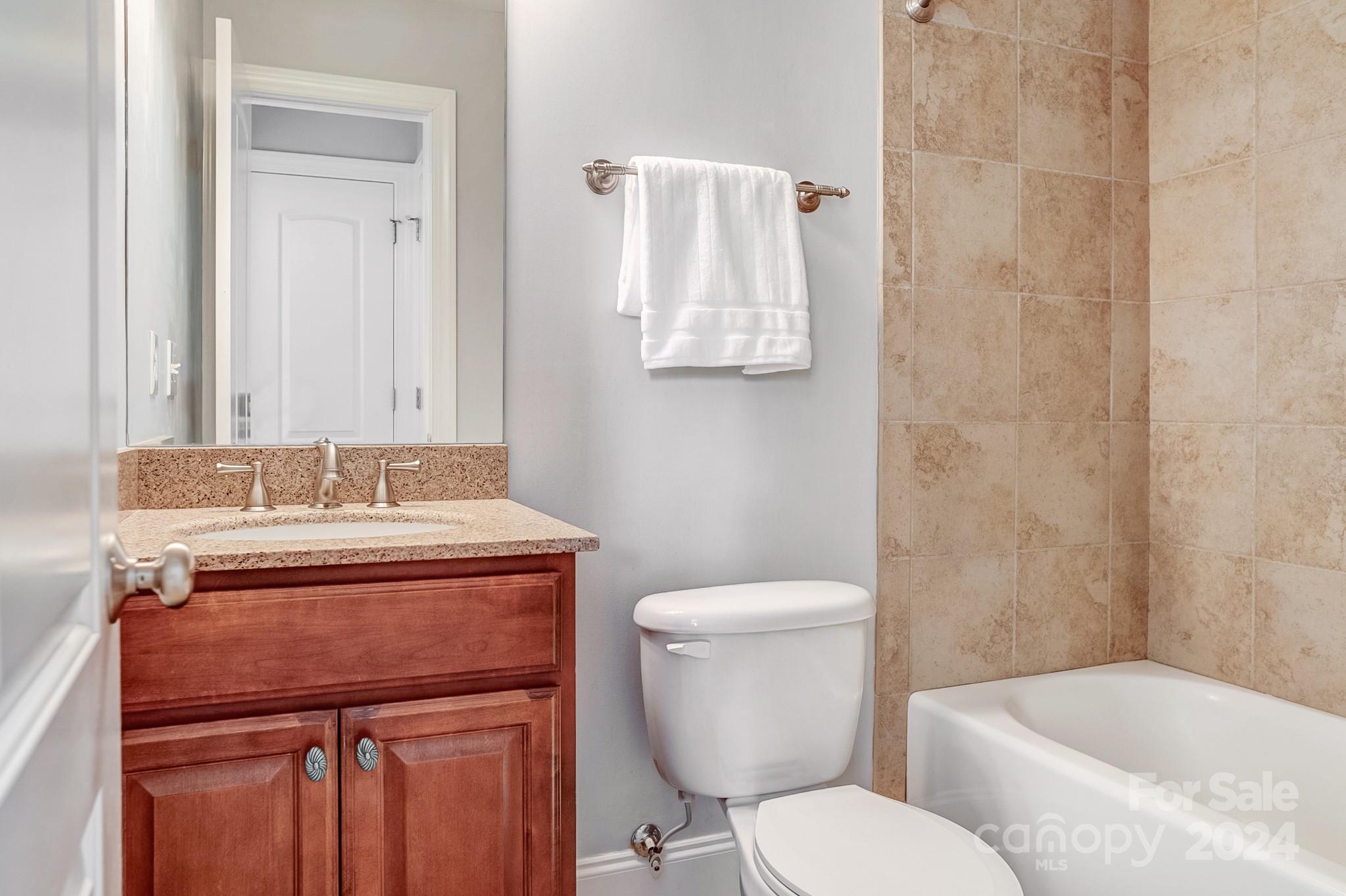 693 Normandy Road Mooresville, NC 28117 - Photo 34 of 48 a bathroom with a granite countertop toilet sink and mirror