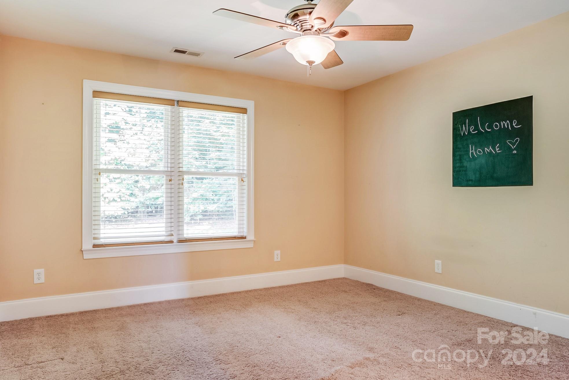 693 Normandy Road Mooresville, NC 28117 - Photo 35 of 48 an empty room with a window and a fan
