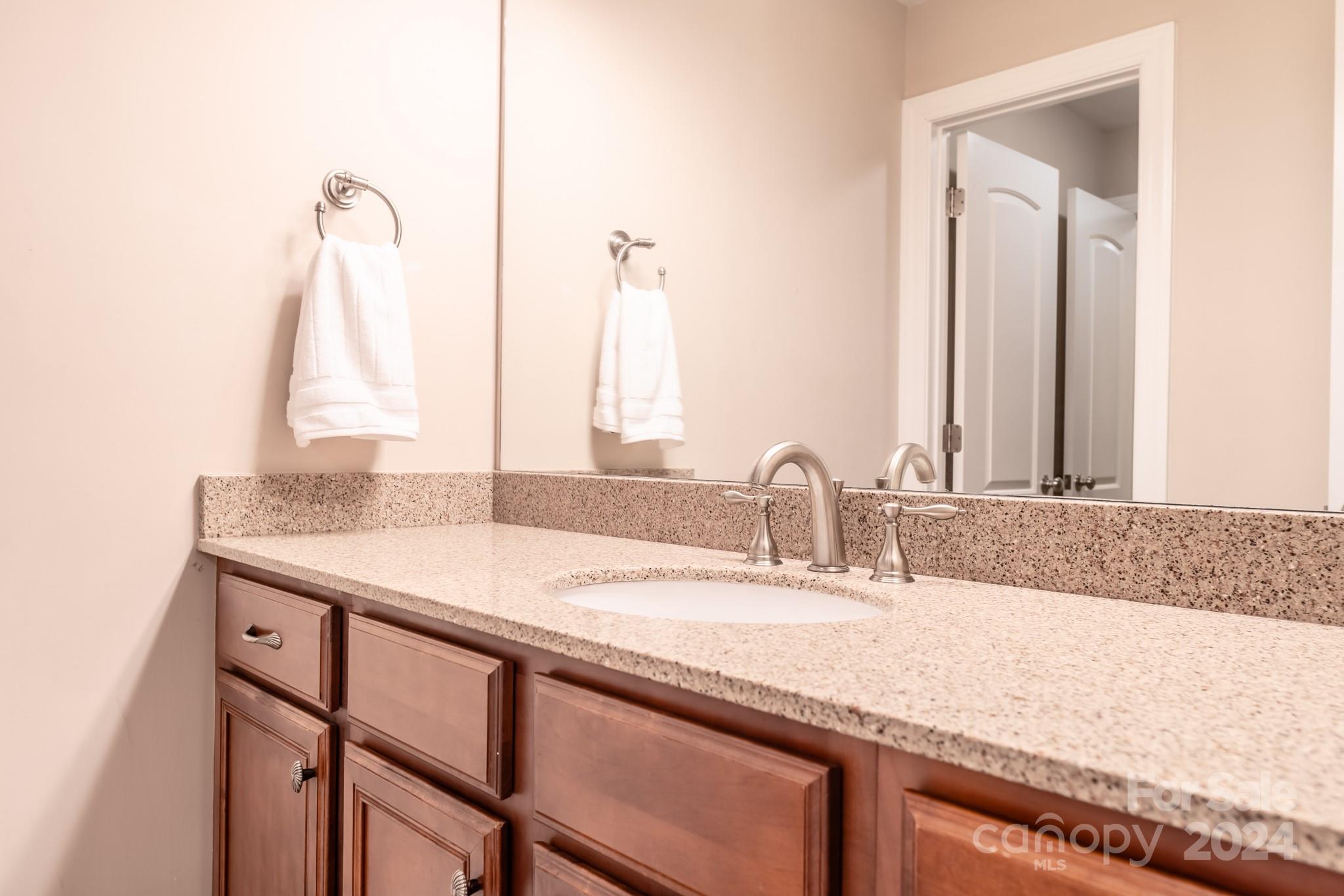 693 Normandy Road Mooresville, NC 28117 - Photo 38 of 48 a bathroom with a granite countertop sink and a mirror