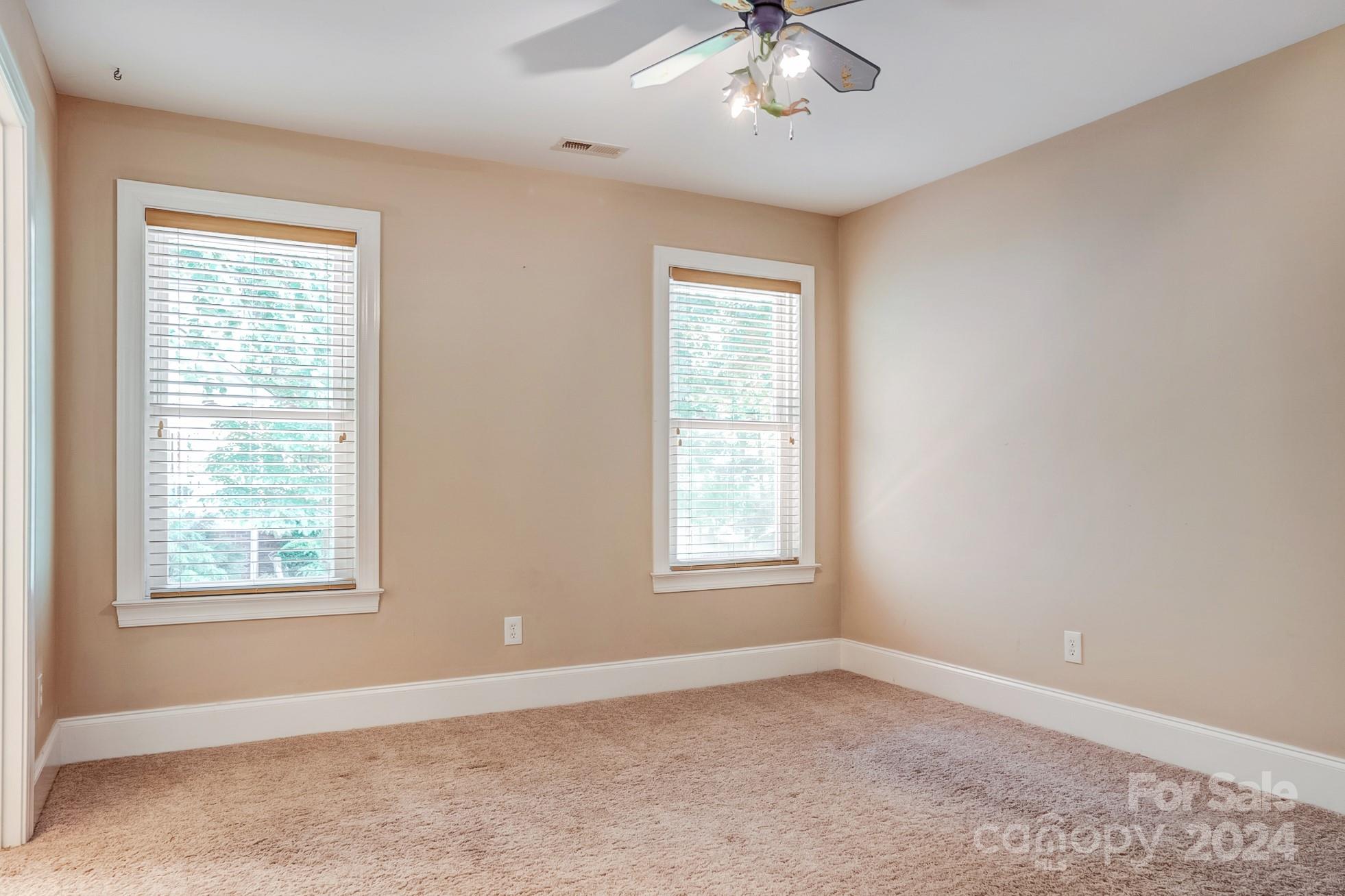 693 Normandy Road Mooresville, NC 28117 - Photo 39 of 48 an empty room with windows and fan
