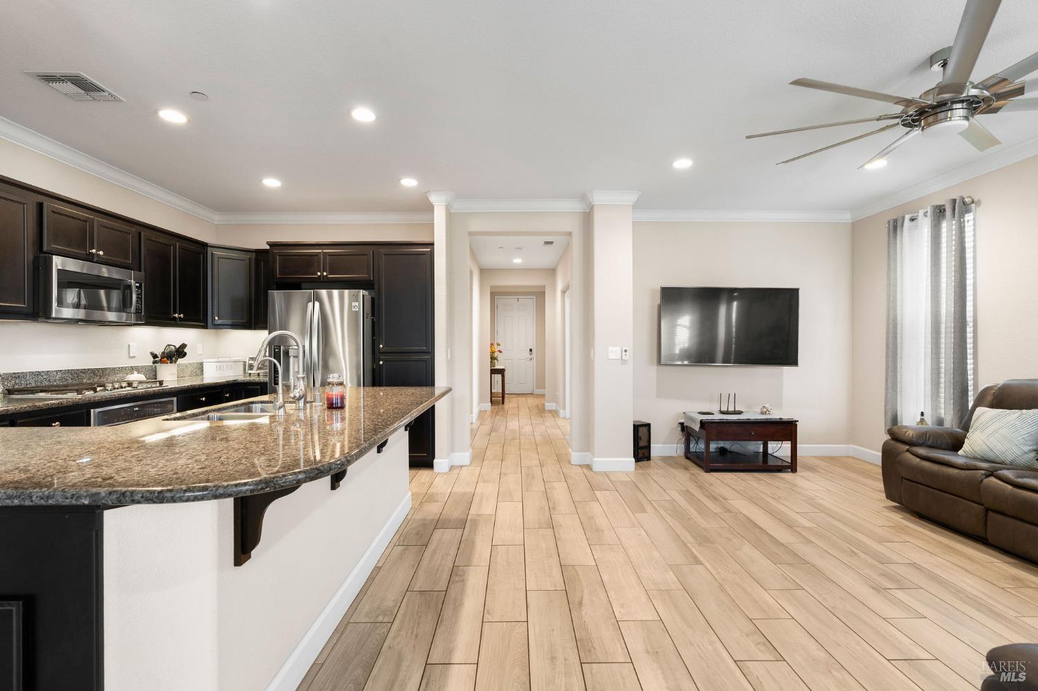 590 Belvedere Drive Rio Vista, CA 94571 - Photo 12 of 63 a large living room with stainless steel appliances granite countertop couches a flat screen tv with kitchen view