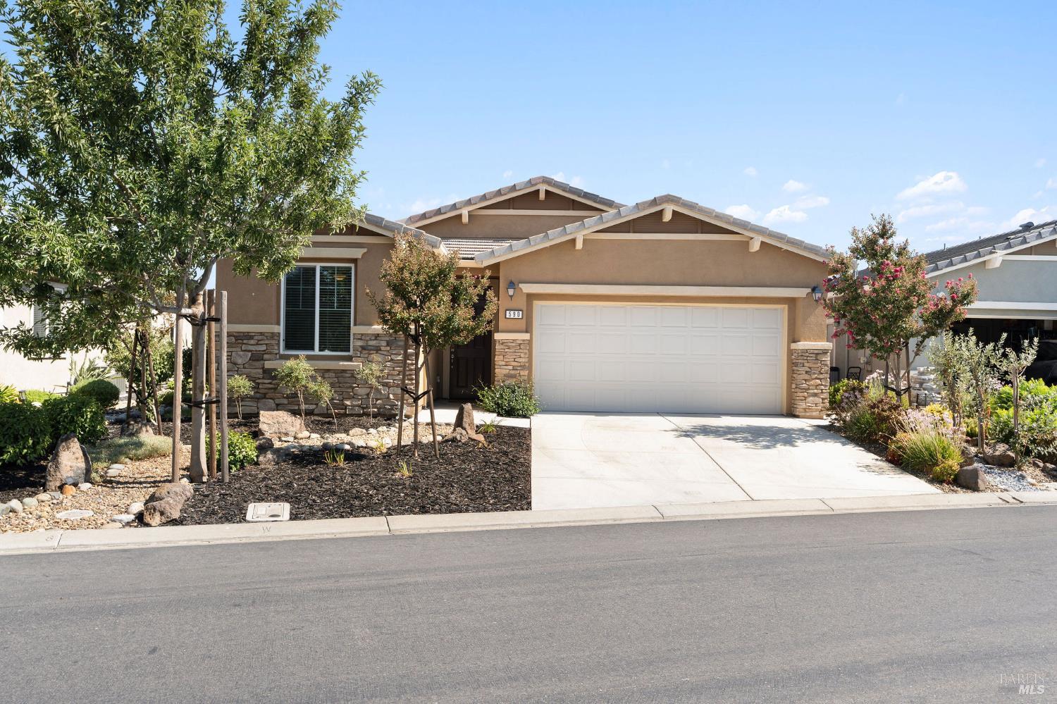 590 Belvedere Drive Rio Vista, CA 94571 - Photo 2 of 63 a front view of a house with a yard and garage