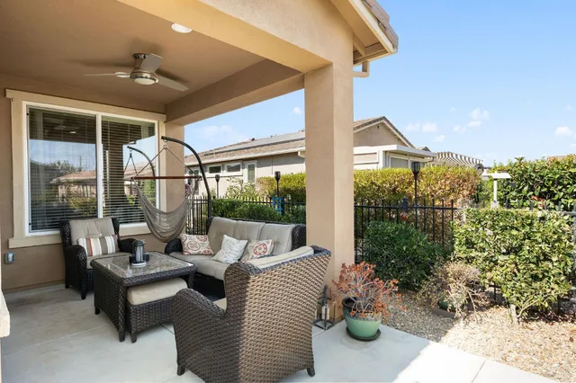 a view of a patio with couches chairs and potted plants