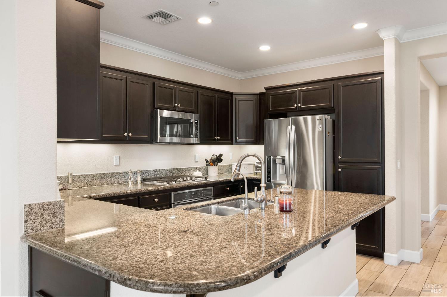 590 Belvedere Drive Rio Vista, CA 94571 - Photo 10 of 63 a kitchen with stainless steel appliances granite countertop a sink and a refrigerator