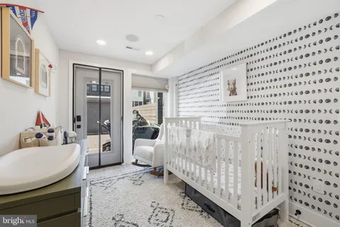 a bedroom with furniture and a rug