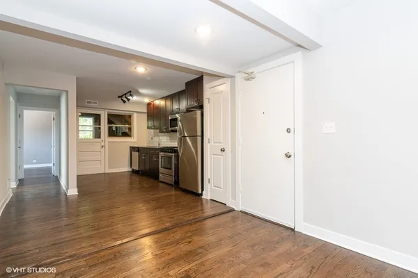 a view of a kitchen with wooden floor and a kitchen