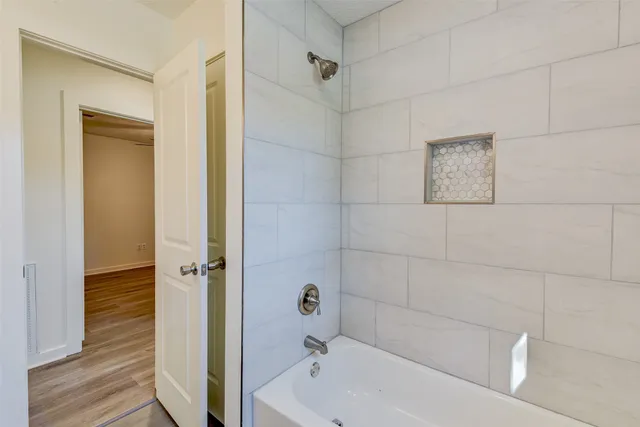 a bathroom with a bathtub and a shower