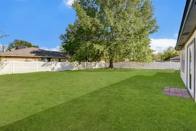 a view of yard with swimming pool and green space