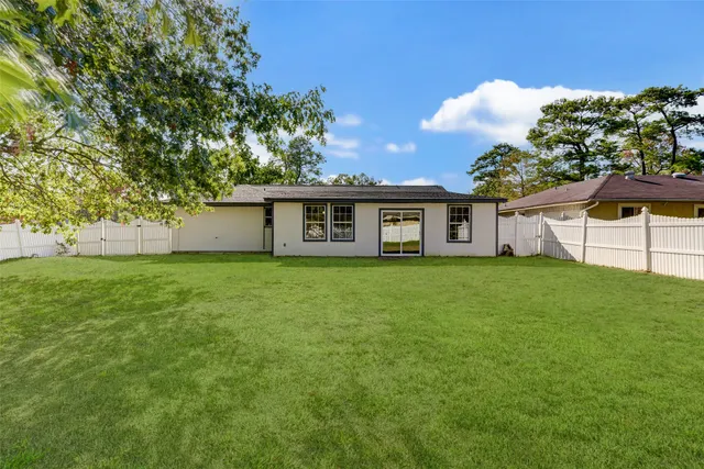 a view of a house with a backyard