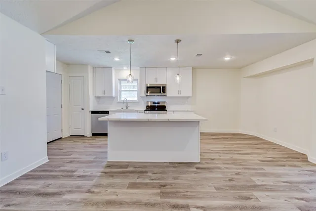 a view of kitchen with microwave oven and cabinets