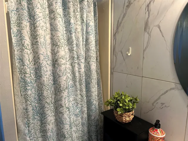 a vase of flowers sitting on a floor