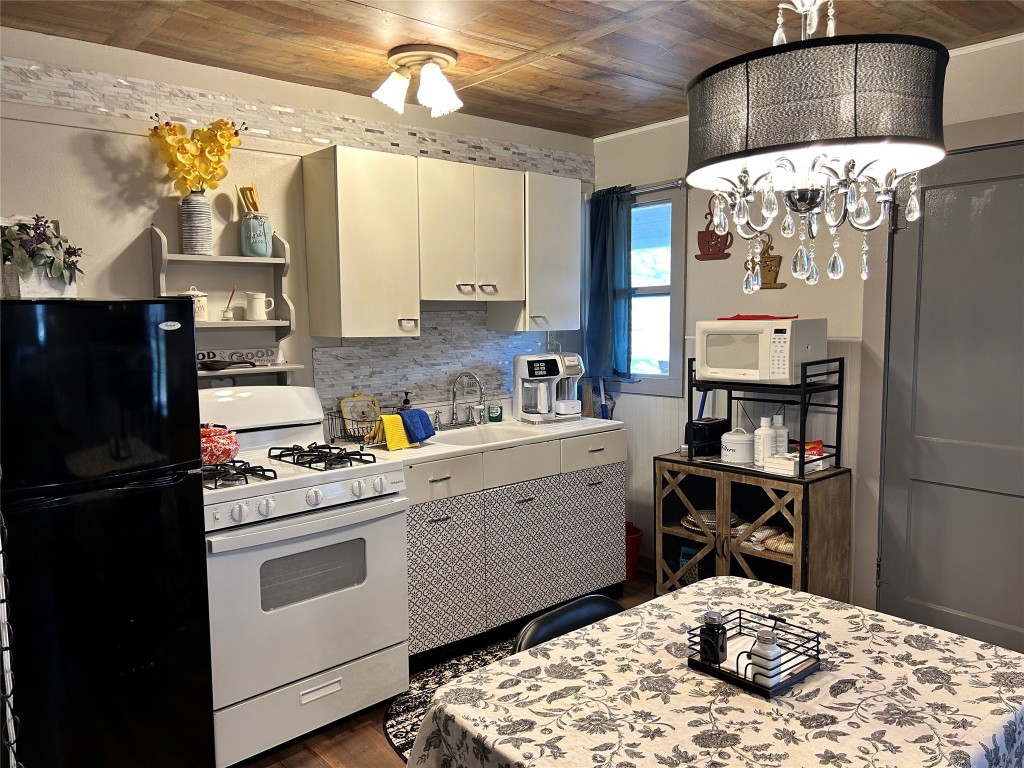 161 Alexander Drive, Unit 8 Tow, TX 78672 - Photo 4 of 13 a kitchen with a sink stove and refrigerator