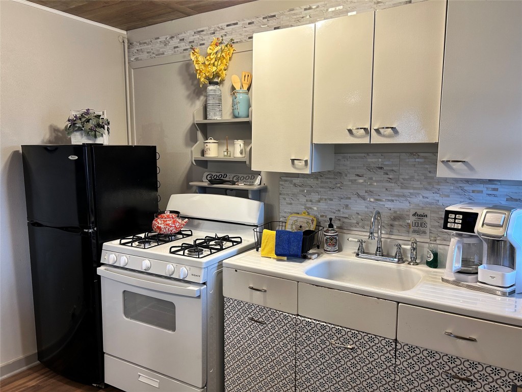161 Alexander Drive, Unit 8 Tow, TX 78672 - Photo 5 of 13 a kitchen with stainless steel appliances a white stove top oven and a refrigerator