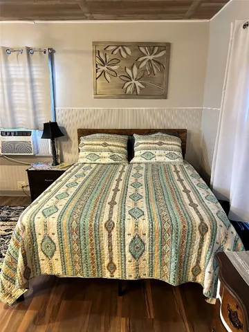 a bed sitting in a bedroom next to a window