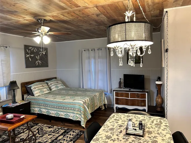 a bedroom with a bed and a chandelier