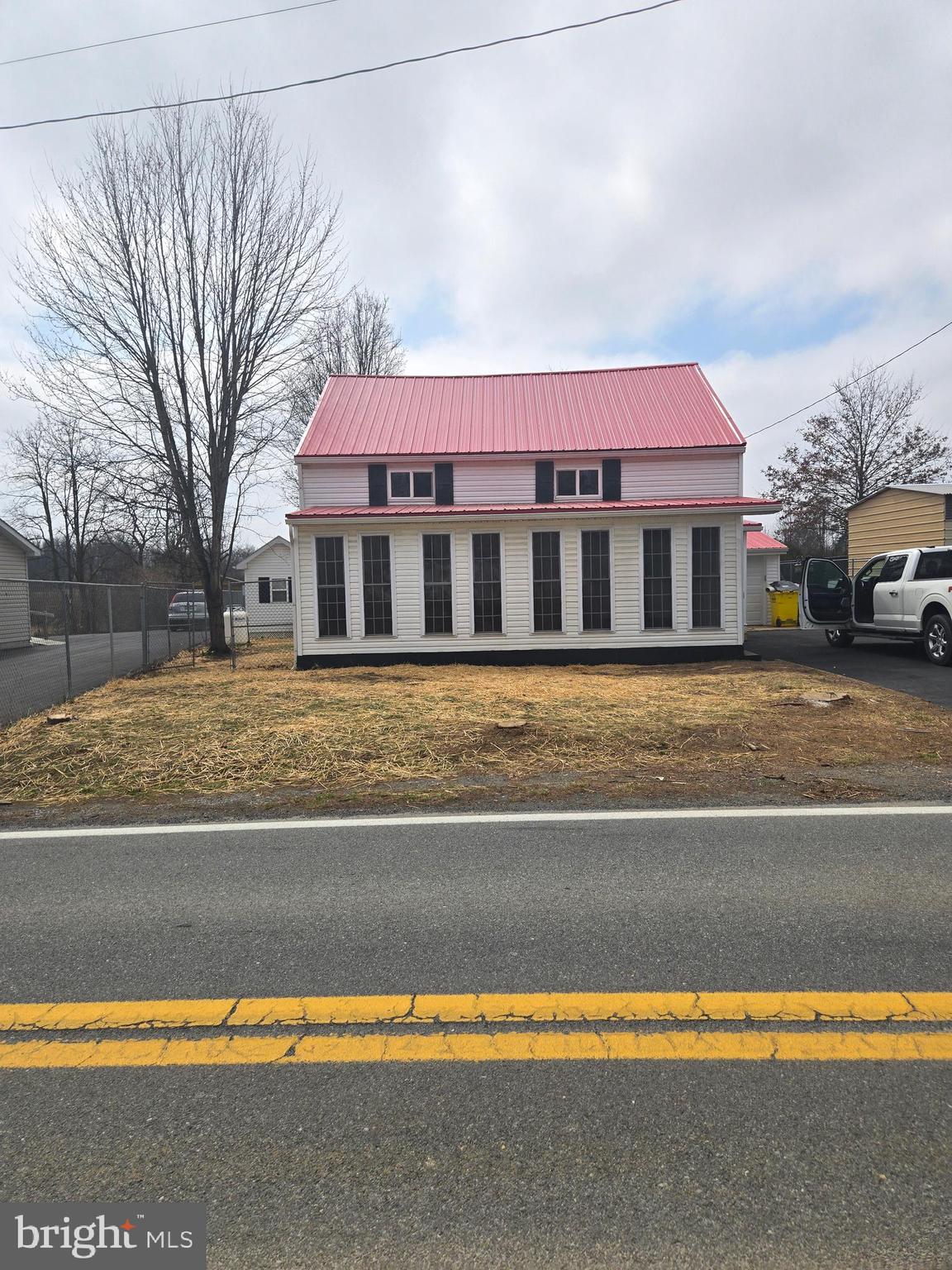 a view of a house with a swimming pool and a yard