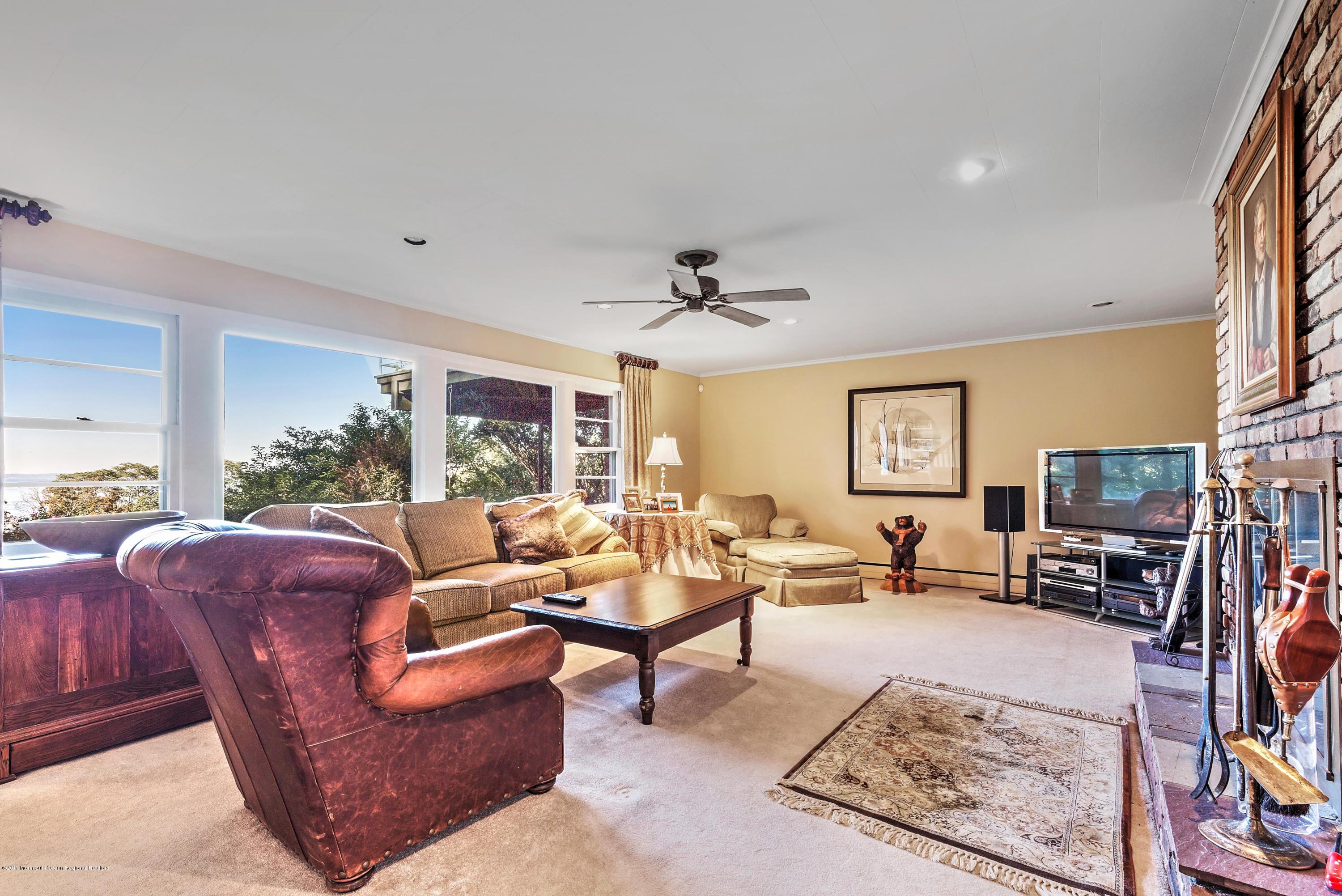 1 Hook Harbor Road Atlantic Highlands, NJ 07716 - Photo 33 of 40 a living room with furniture and a flat screen tv with wooden floor