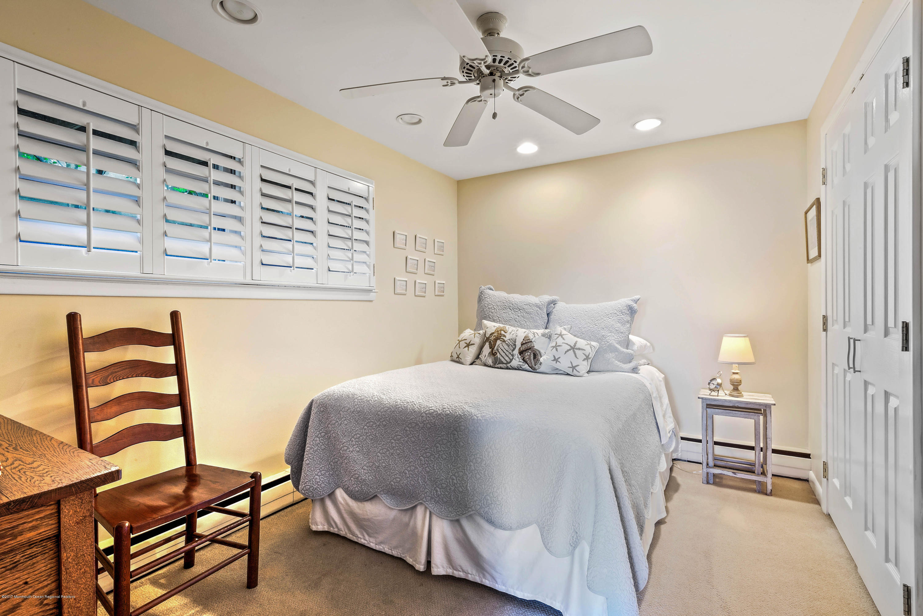1 Hook Harbor Road Atlantic Highlands, NJ 07716 - Photo 36 of 40 a bedroom with a bed and a chandelier