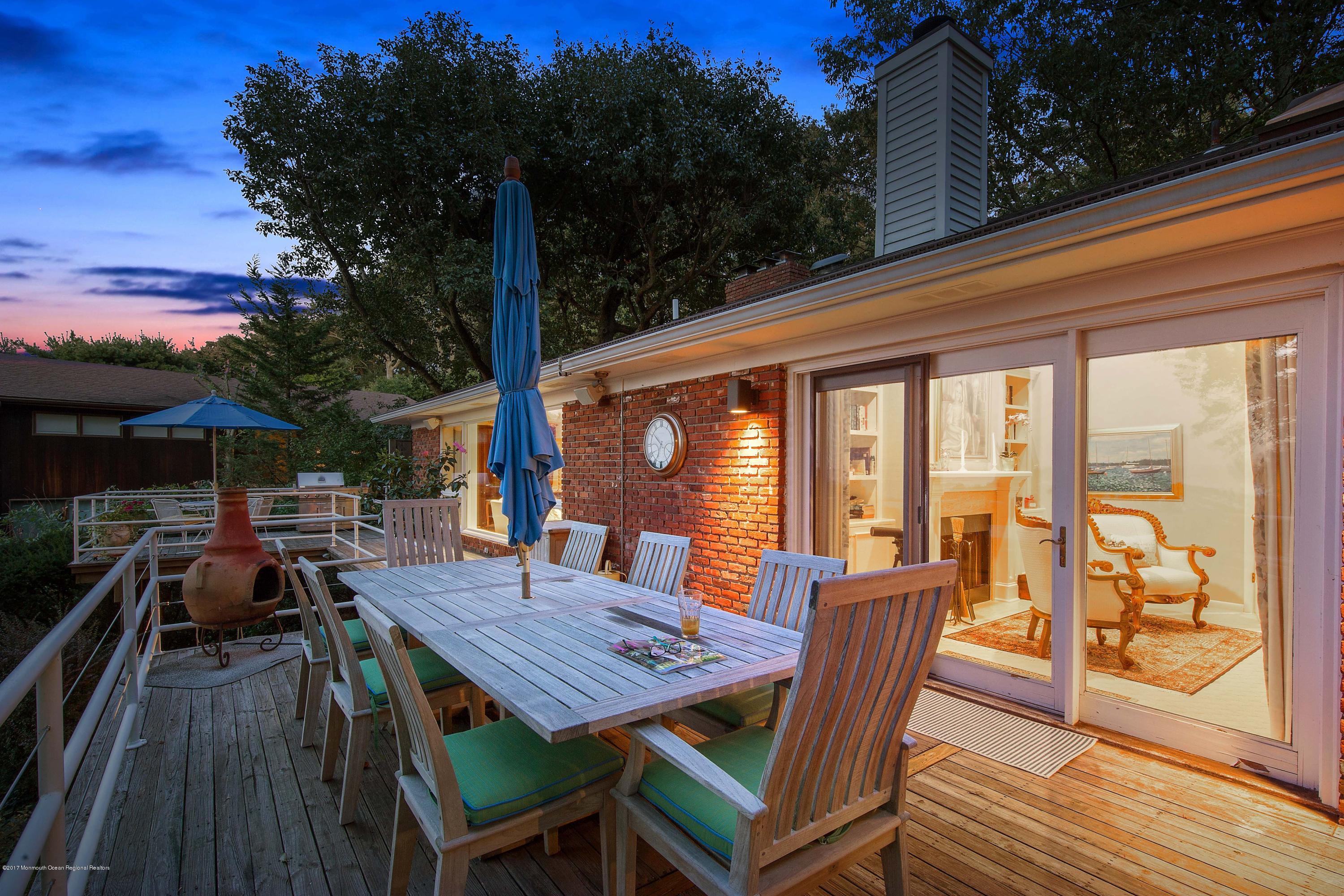 1 Hook Harbor Road Atlantic Highlands, NJ 07716 - Photo 7 of 40 a view of a patio with table and chairs with wooden floor and fence