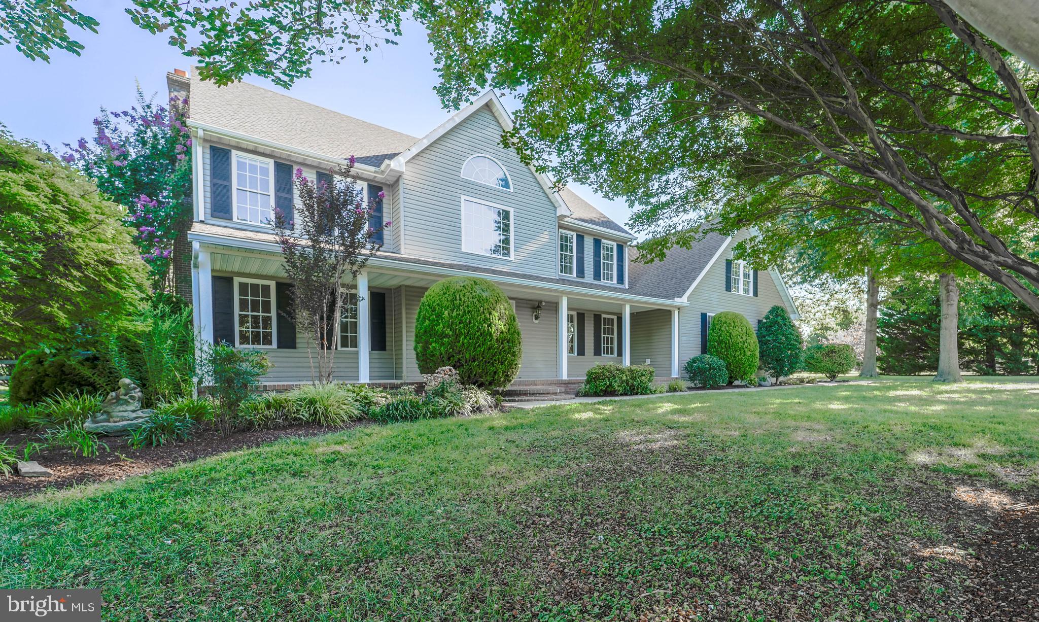 144 River Run Queenstown, MD 21658 - Photo 12 of 52 a front view of a house with a yard and trees