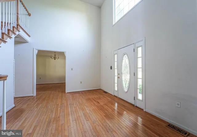 a view of a livingroom with wooden floor and a fireplace
