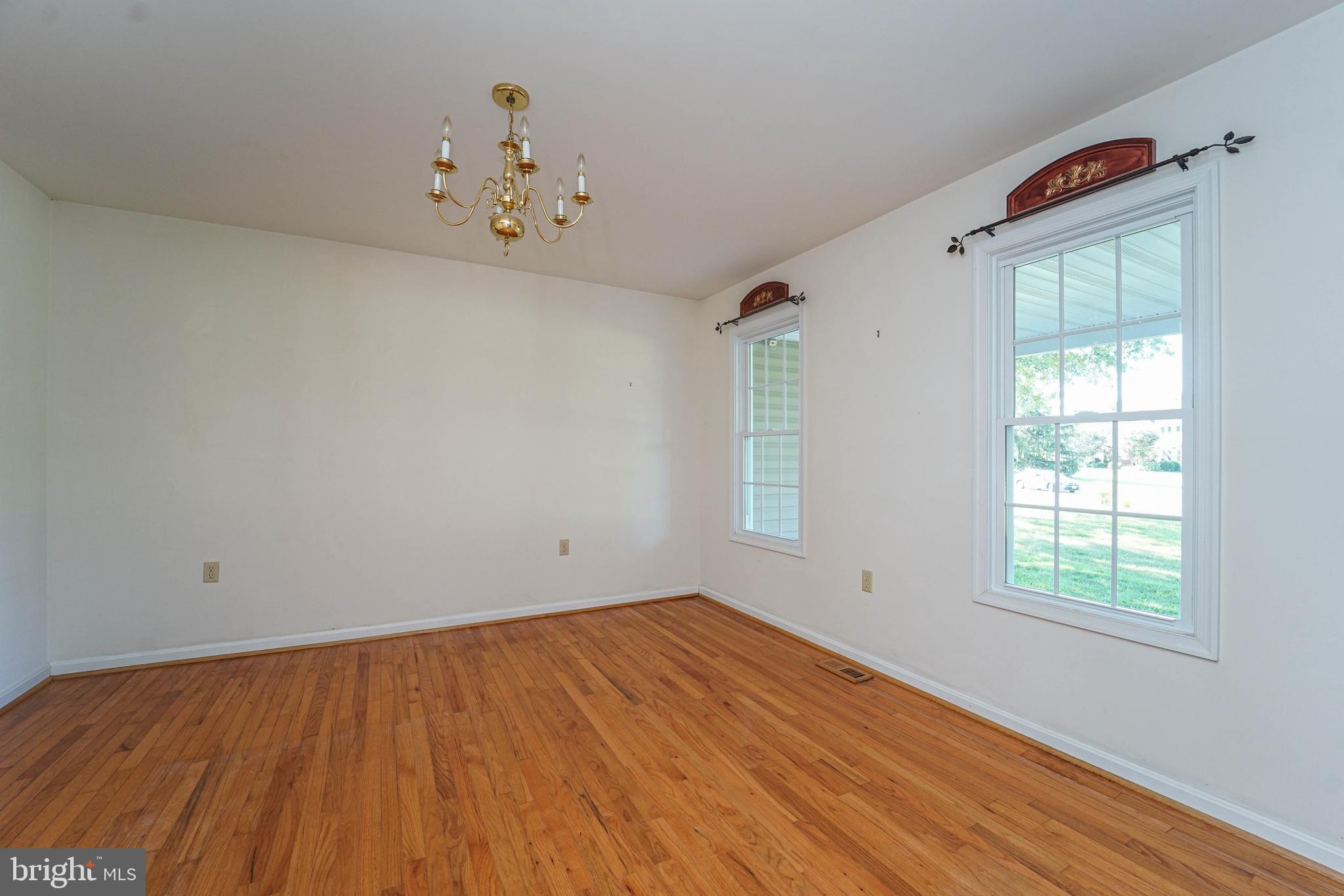 144 River Run Queenstown, MD 21658 - Photo 23 of 52 an empty room with chandelier fan and windows
