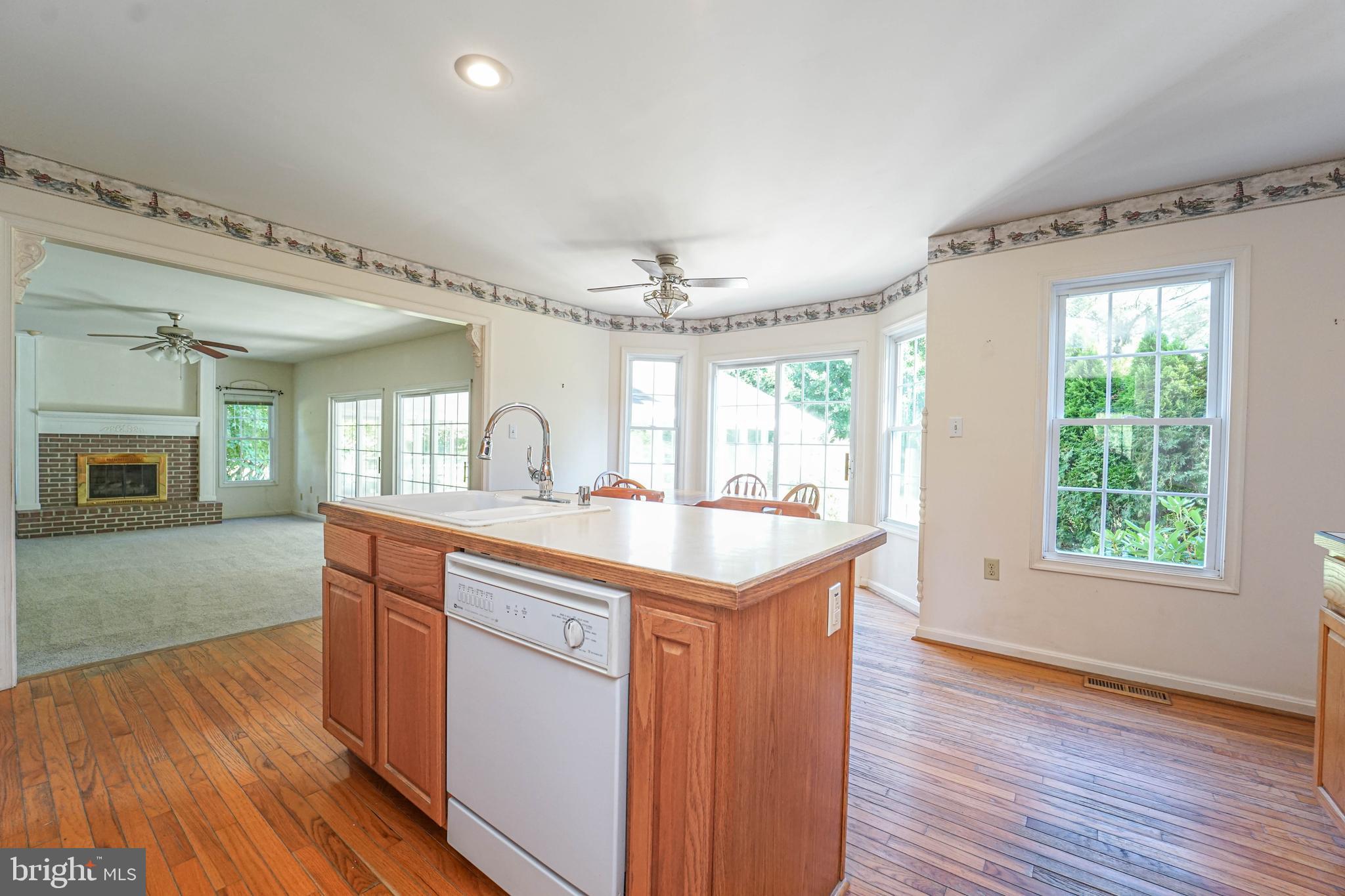 144 River Run Queenstown, MD 21658 - Photo 27 of 52 a kitchen with kitchen island granite countertop wooden floors and sink