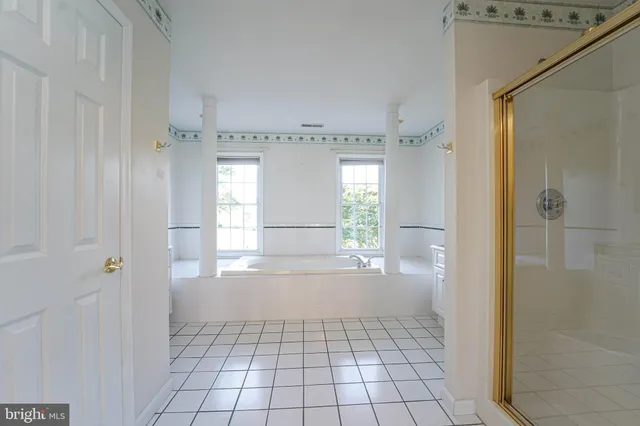 a bathroom with a bathtub sink and mirror