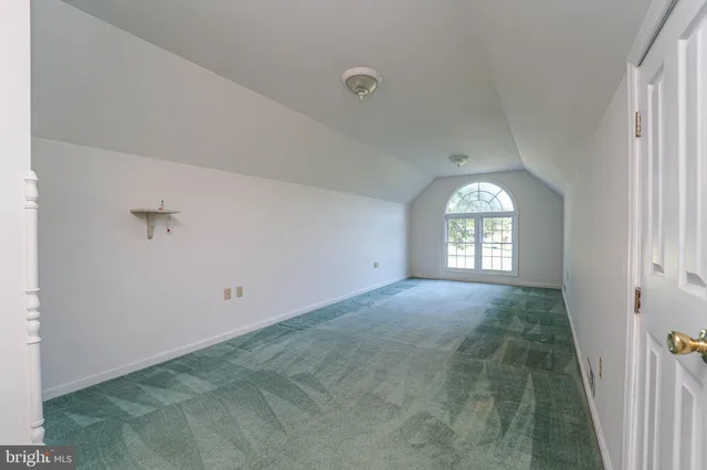 a view of a livingroom with a ceiling fan and window