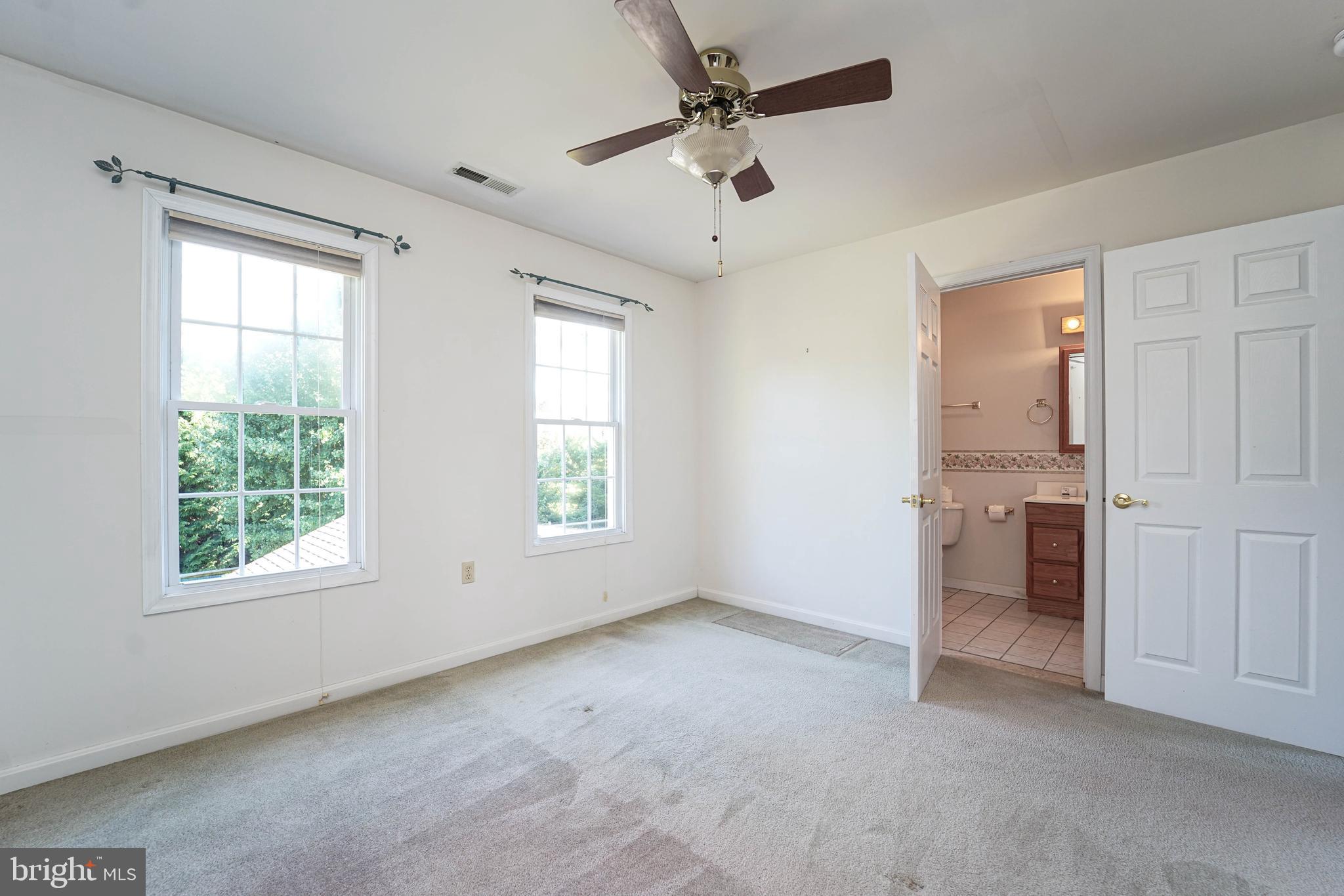 144 River Run Queenstown, MD 21658 - Photo 46 of 52 an empty room with a ceiling fan and a window