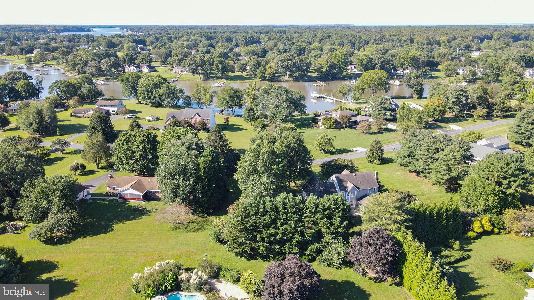 144 River Run Queenstown, MD 21658 - Photo 7 of 52 an aerial view of green landscape with trees houses and lake view