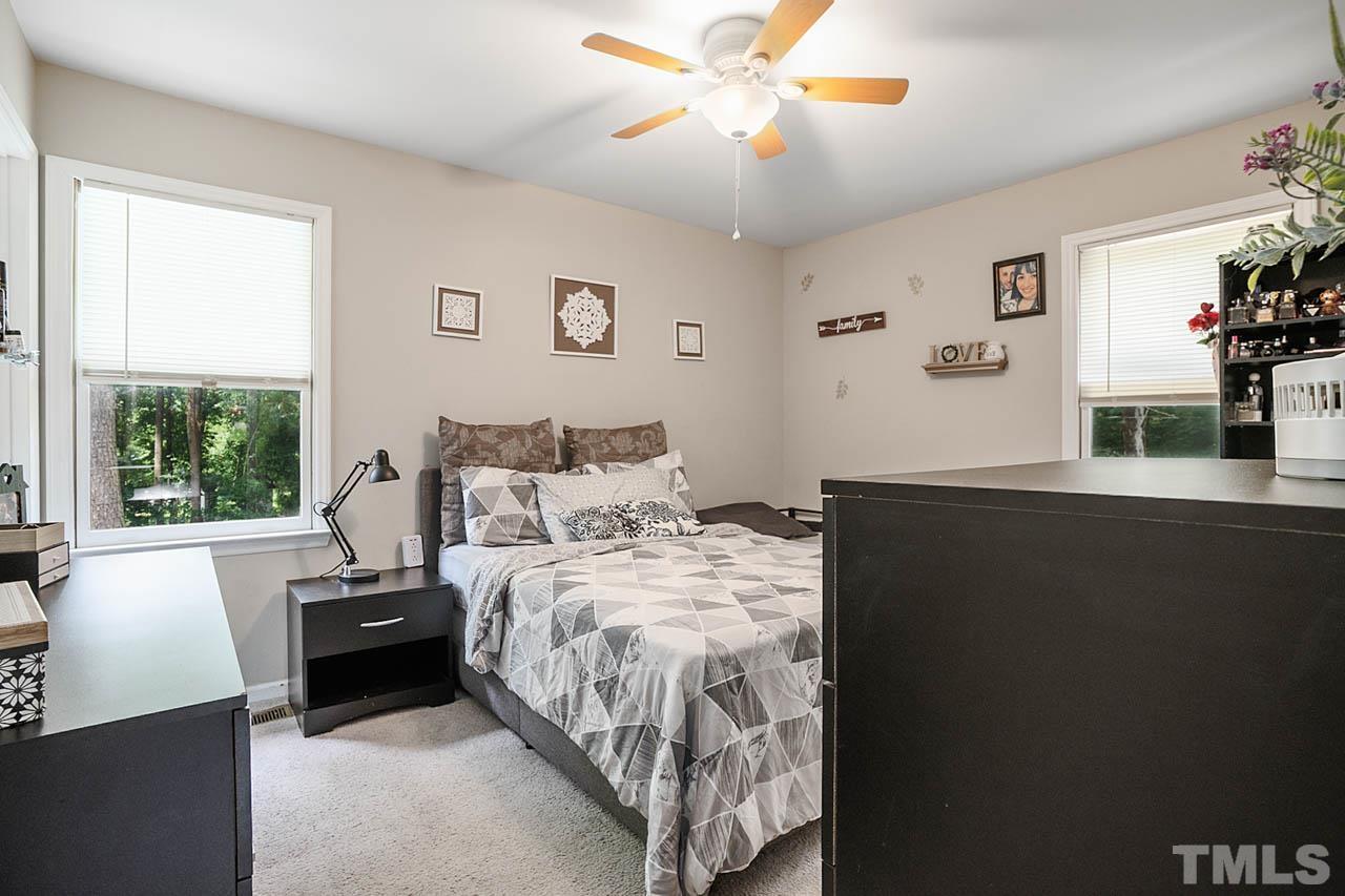 479 Ridgecrest Trail Henderson, NC 27537 - Photo 13 of 19 a bedroom with a bed and a chandelier