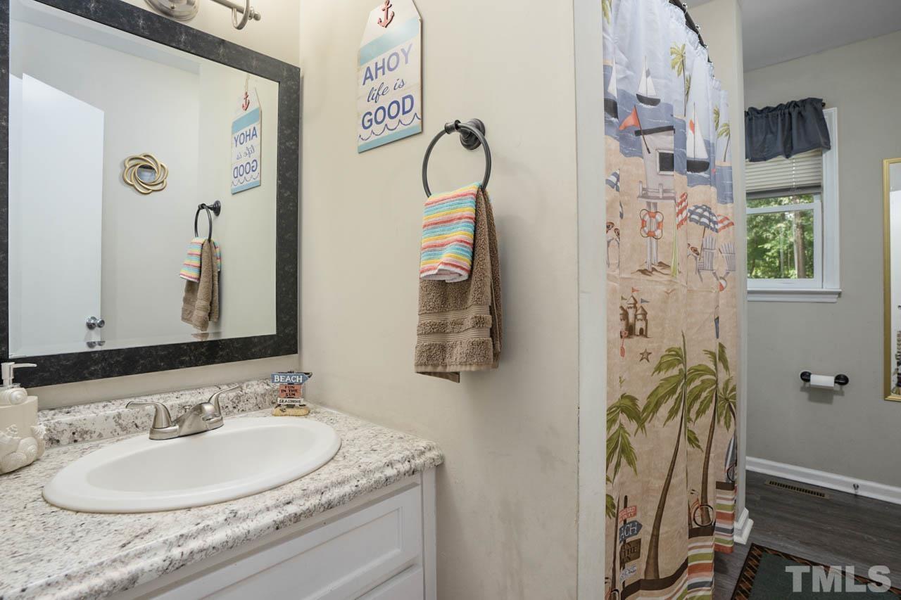479 Ridgecrest Trail Henderson, NC 27537 - Photo 17 of 19 a bathroom with a granite countertop sink and a mirror