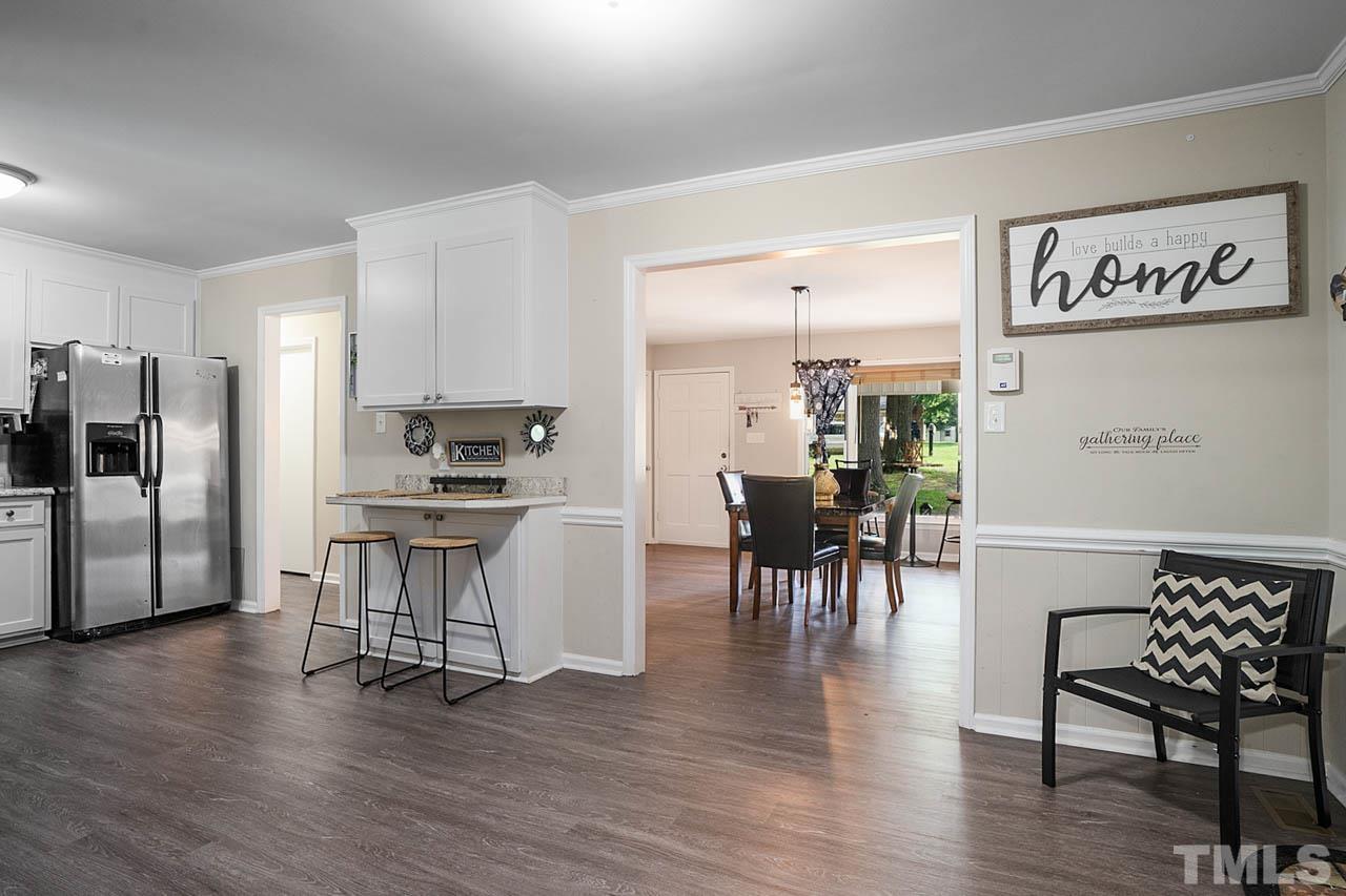 479 Ridgecrest Trail Henderson, NC 27537 - Photo 8 of 19 a kitchen with stainless steel appliances kitchen island hardwood floor and a table