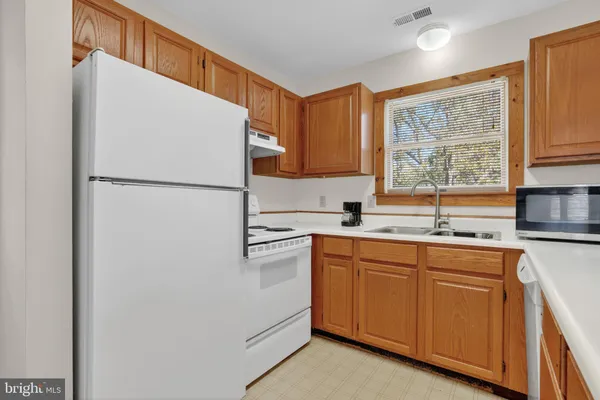 a white refrigerator freezer sitting inside of a kitchen