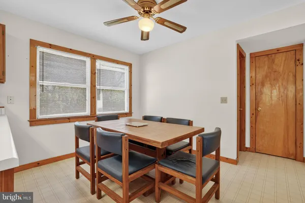 a dining room with a table and chairs