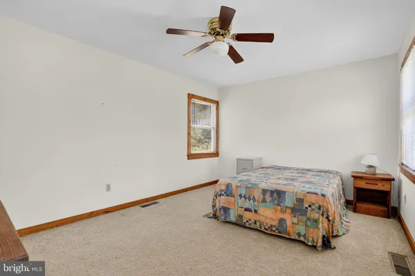 a bedroom with a bed and a baby bed