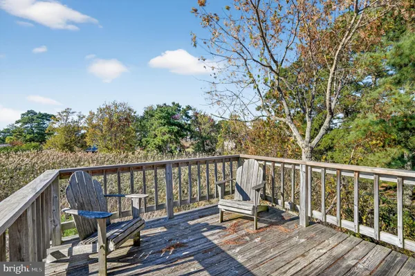a view of balcony with wooden floor and outdoor seating