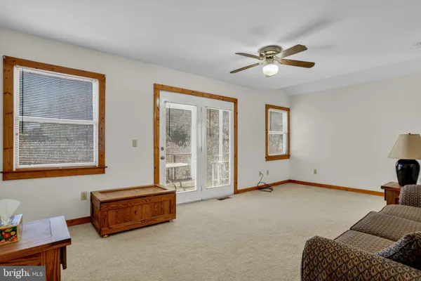 a living room with furniture gym equipment and a window