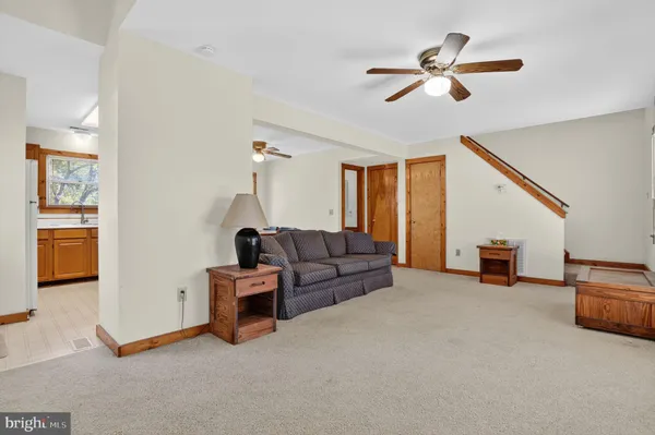 a living room with furniture and a ceiling fan
